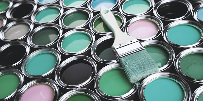 Tin cans with paint and brushes